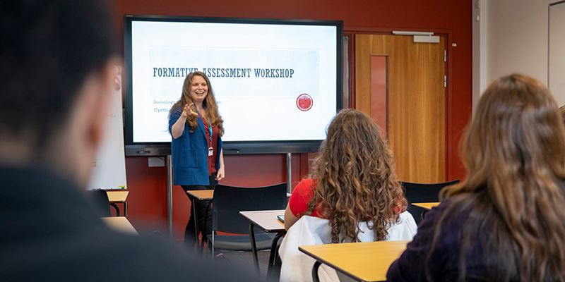 Lecturer delivering a seminar to a room of students